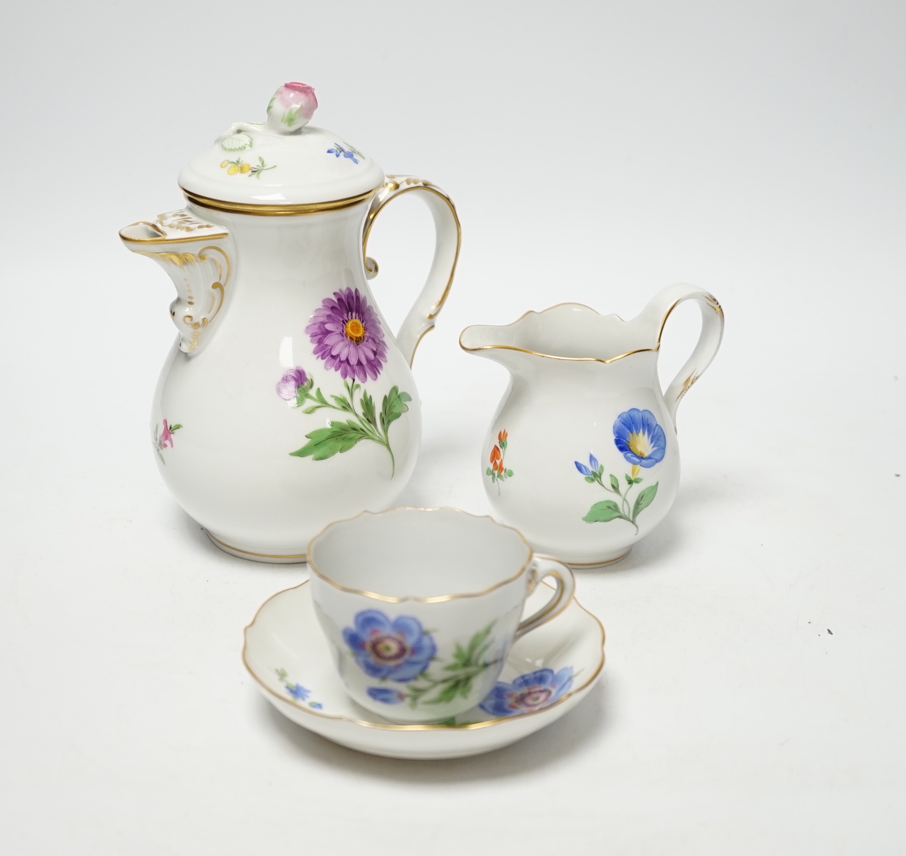 A 20th century Meissen coffee set with floral decoration, comprising a coffee pot, a milk jug, a lidded sugar bowl, and six cups and saucers, coffee pot, 17cm high